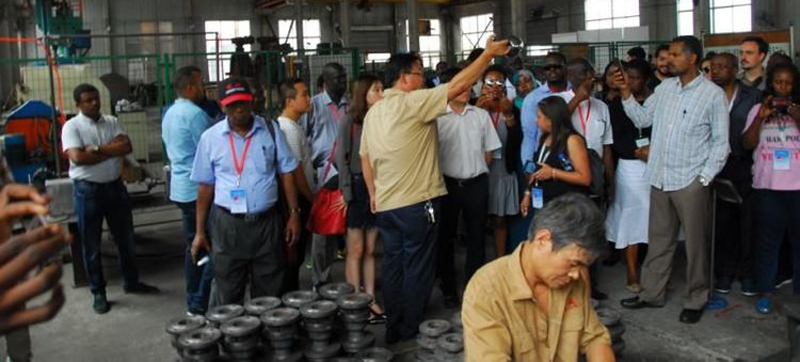 Delegation observing the mirror-finish machining of ball valve components
