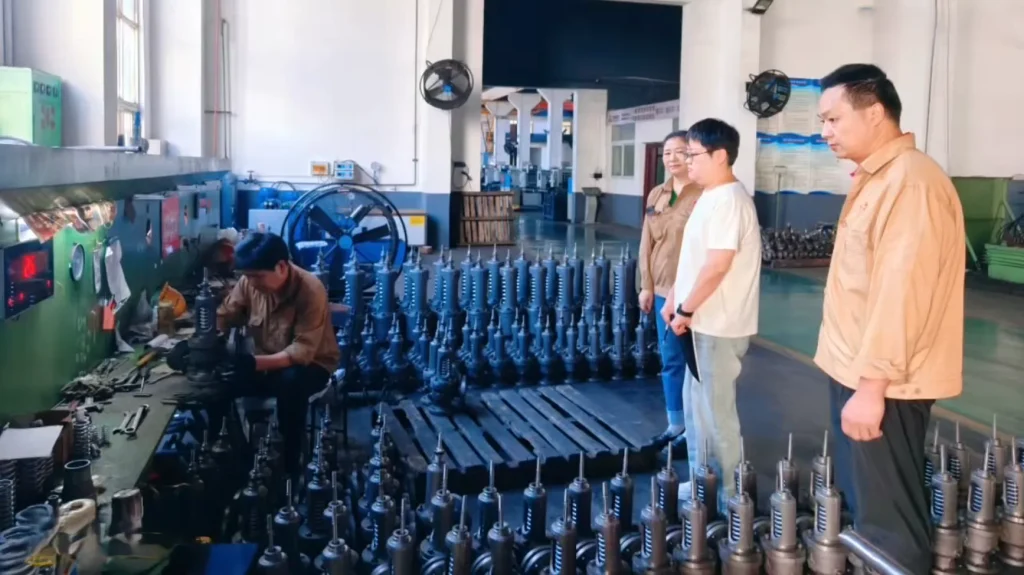 EU Notified Body audit team reviewing a batch of finished steam traps on the Gaoshan Valve workshop floor during the 2026 PED Module H surveillance audit