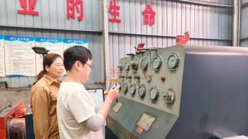EU Notified Body auditor photographing the hydrostatic pressure test bench gauges as evidence for the PED Module H audit file